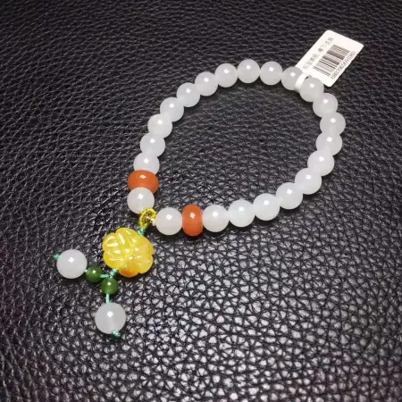 8mm Hetian White Jade single-loop bracelet is a fashionable and versatile accessory. It is paired with a beeswax Chinese knot in South red 8mm Hetian White Jade single-loop bracelet is a fashionable and versatile accessory. It is paired with a beeswax Chinese knot in South red